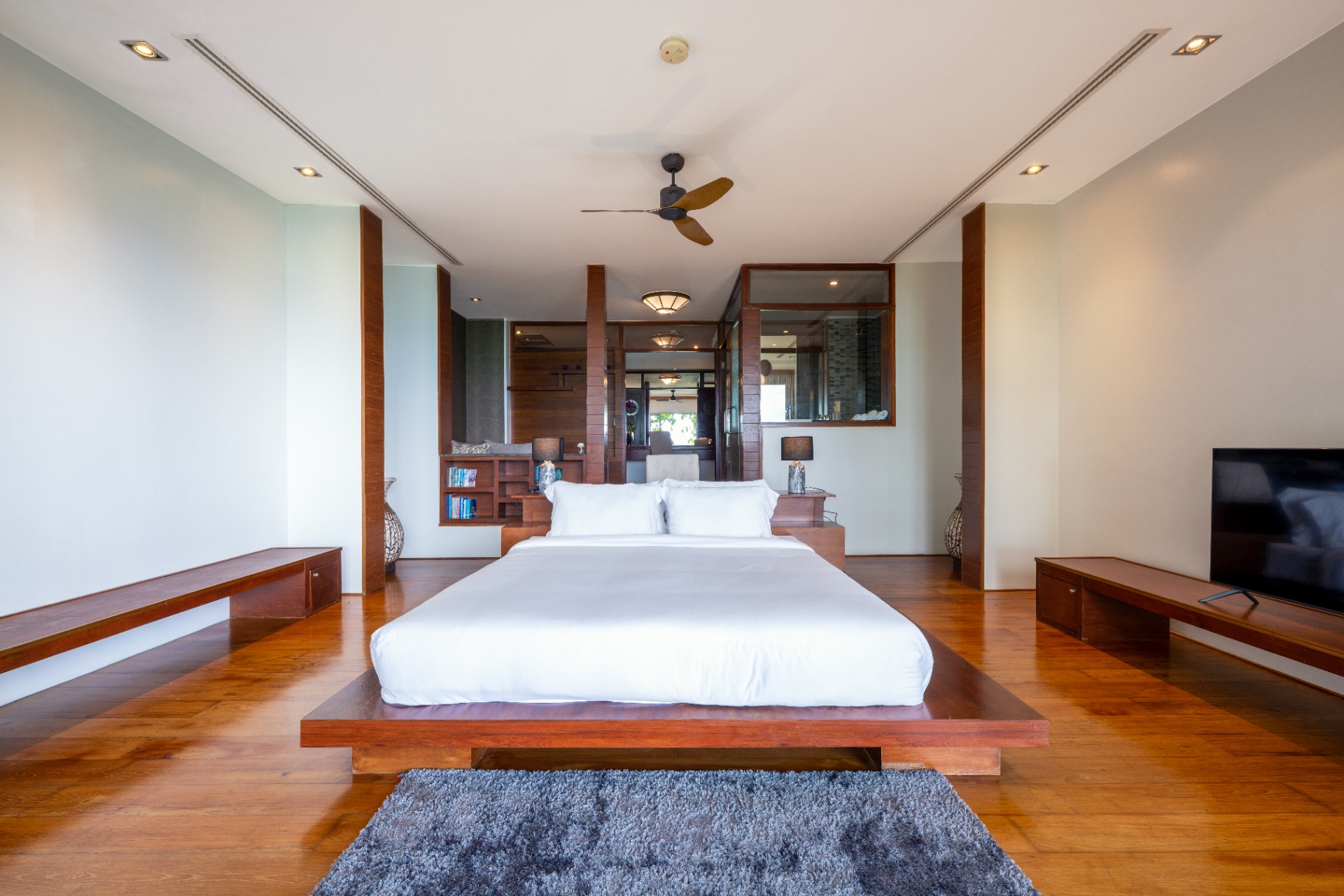 Symmetrical master suite with platform bed and sea outlook