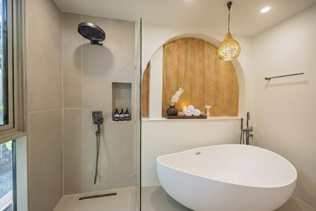 En-suite bathroom with rainfall shower and freestanding tub