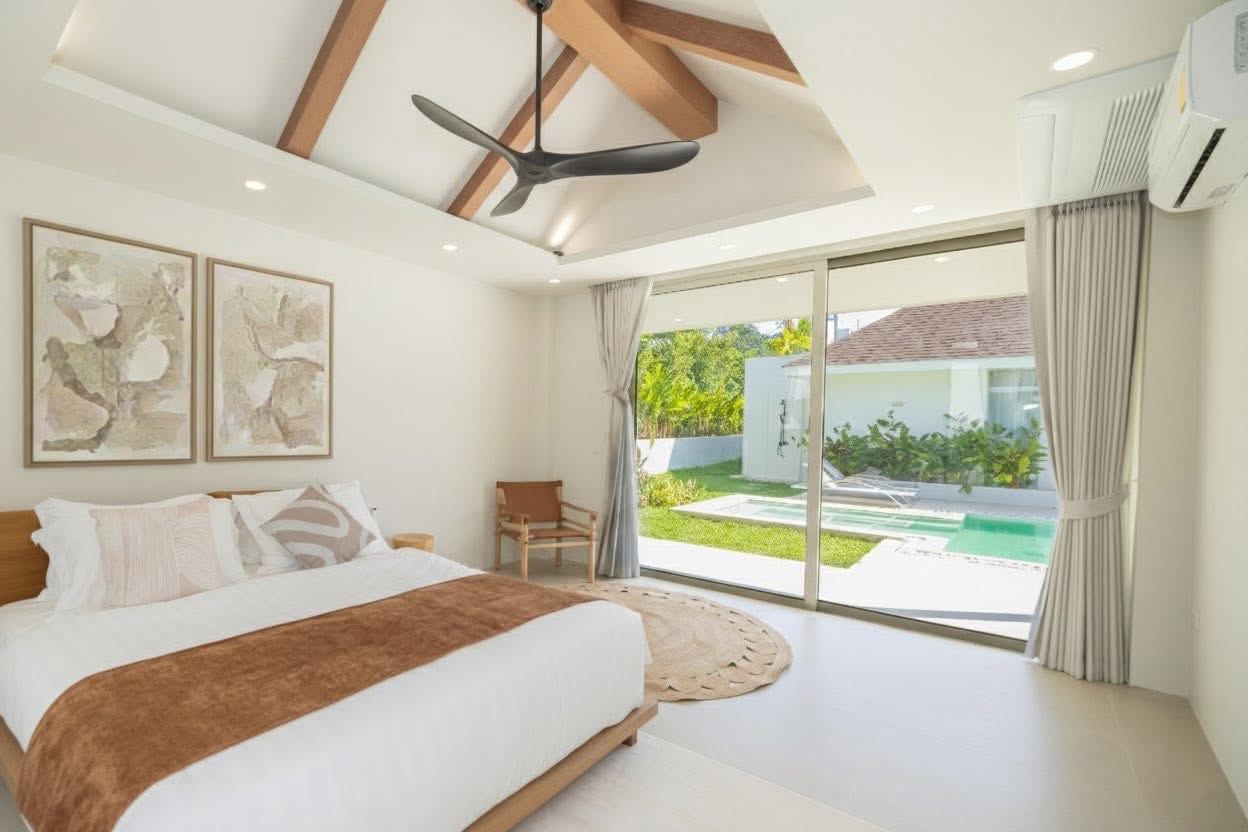 Master bedroom with vaulted ceiling and direct pool access