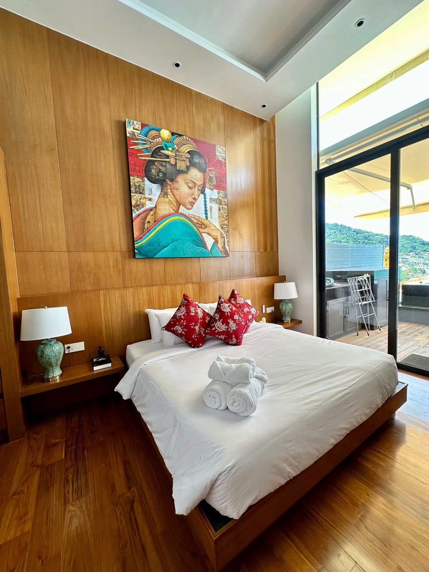 Guest bedroom with feature artwork and private sea-view terrace