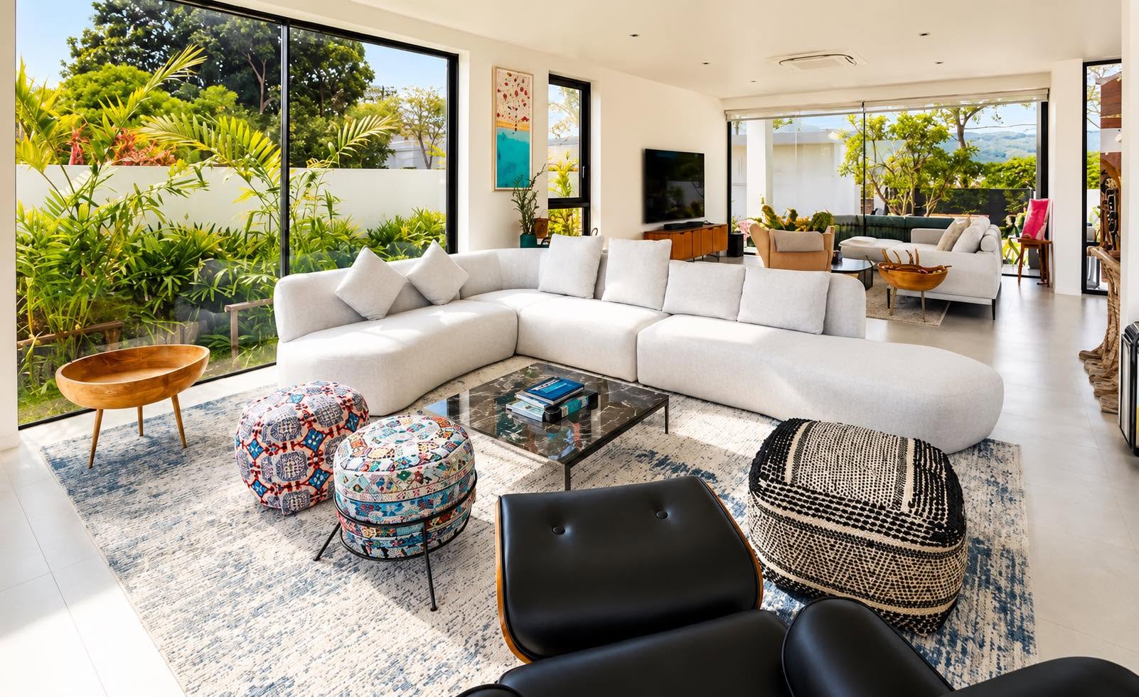 Living room with curved sectional sofa and garden view
