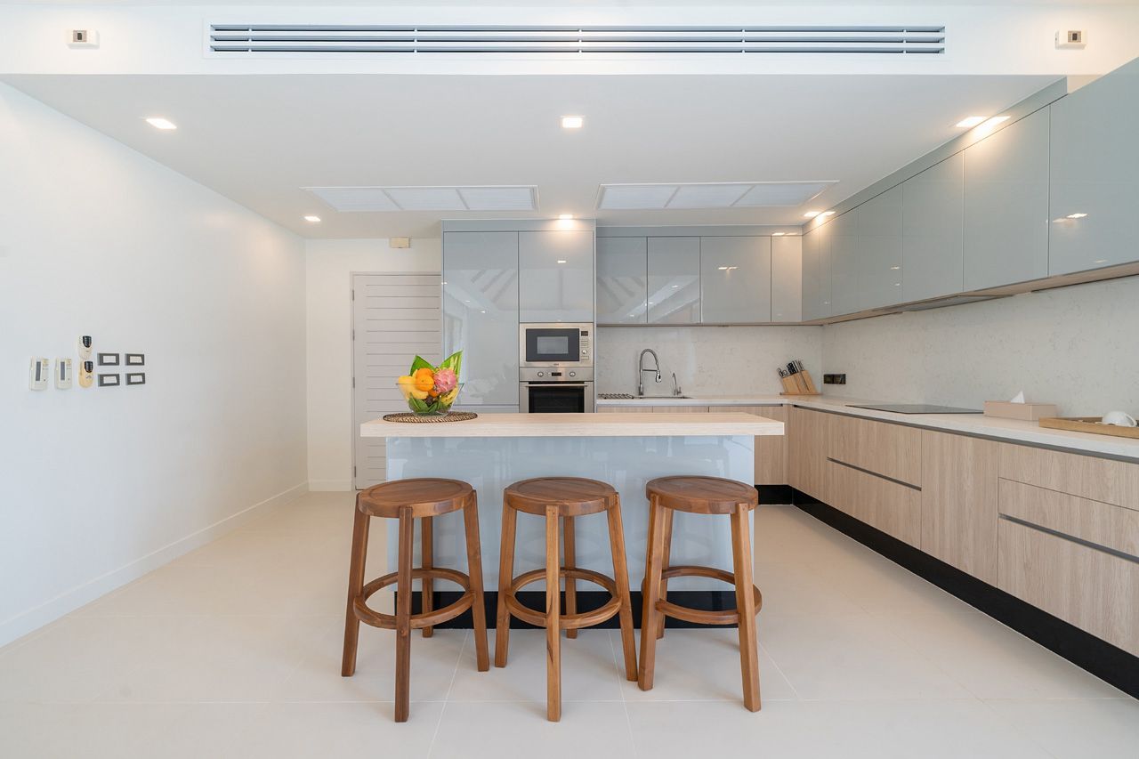 Modern kitchen with island breakfast bar and teak stools