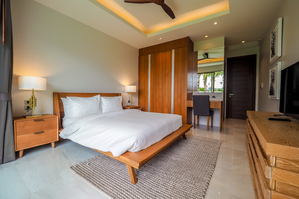 Fourth bedroom with timber wardrobes and desk