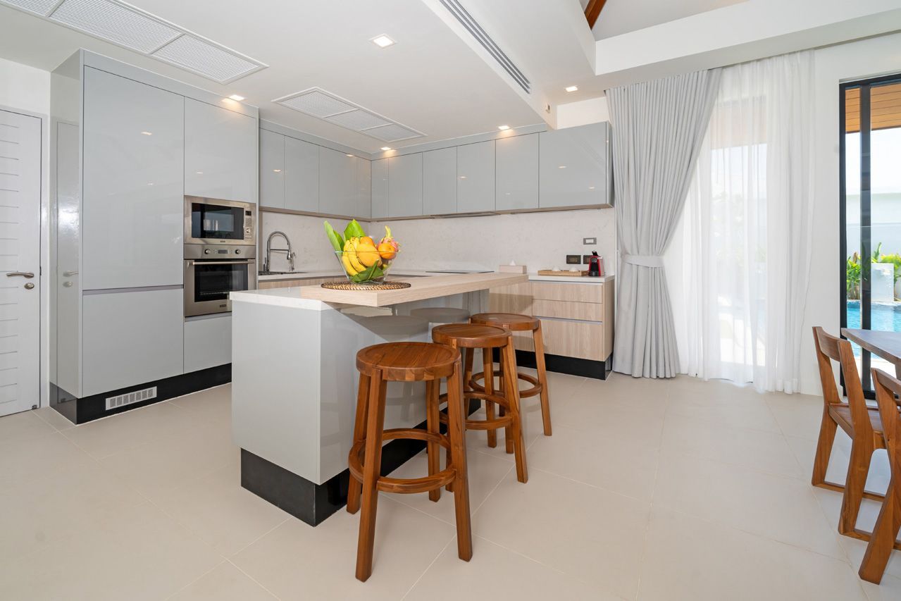 Open kitchen with breakfast bar and adjacent dining area