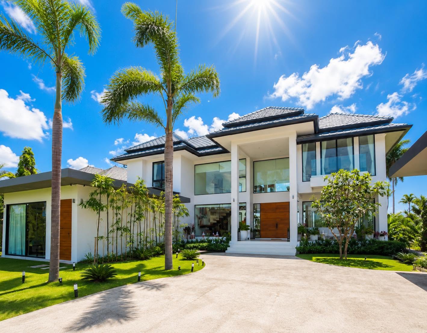 Villa exterior with driveway and royal palms
