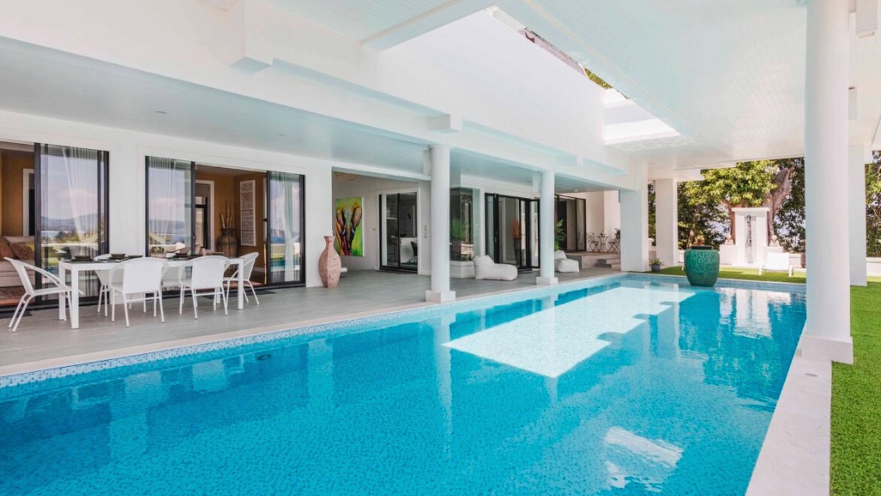 Swimming pool with adjacent alfresco dining terrace and ocean view