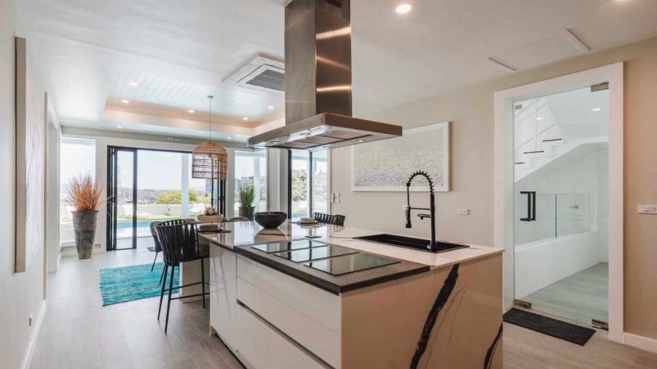 Designer European kitchen with marble island and stainless extractor