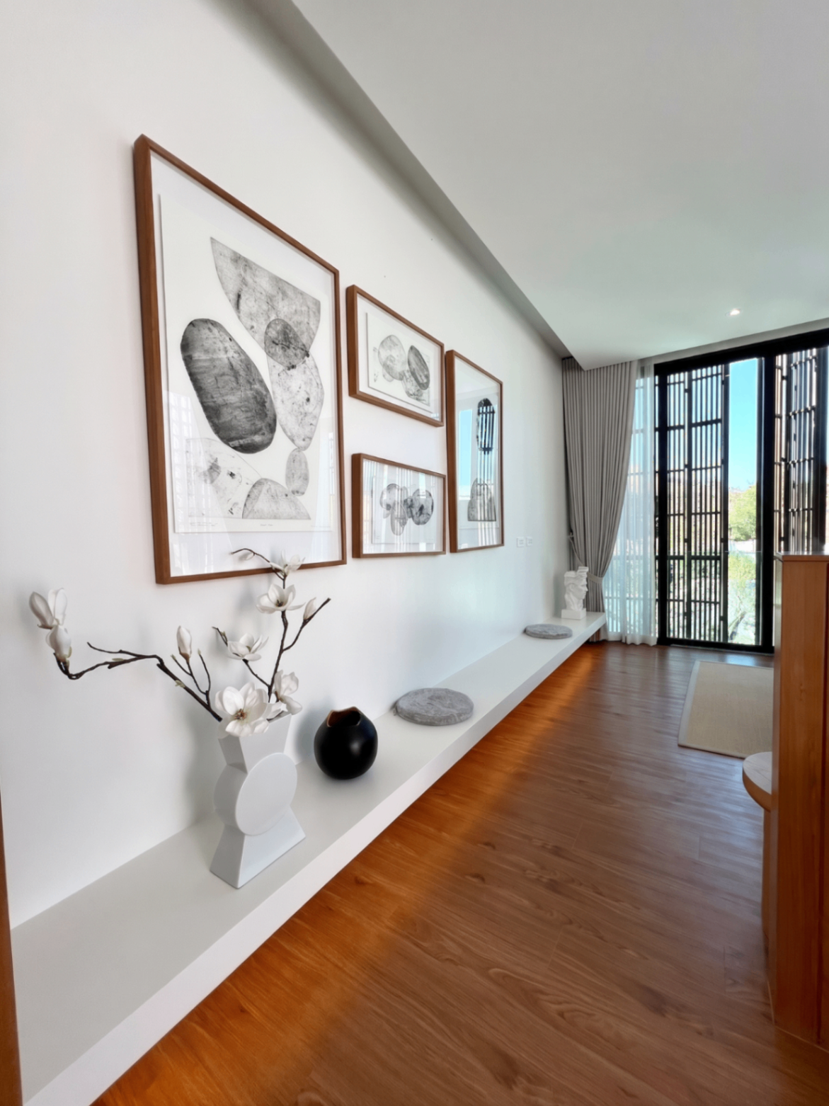 Gallery wall corridor with framed artwork and built-in ledge