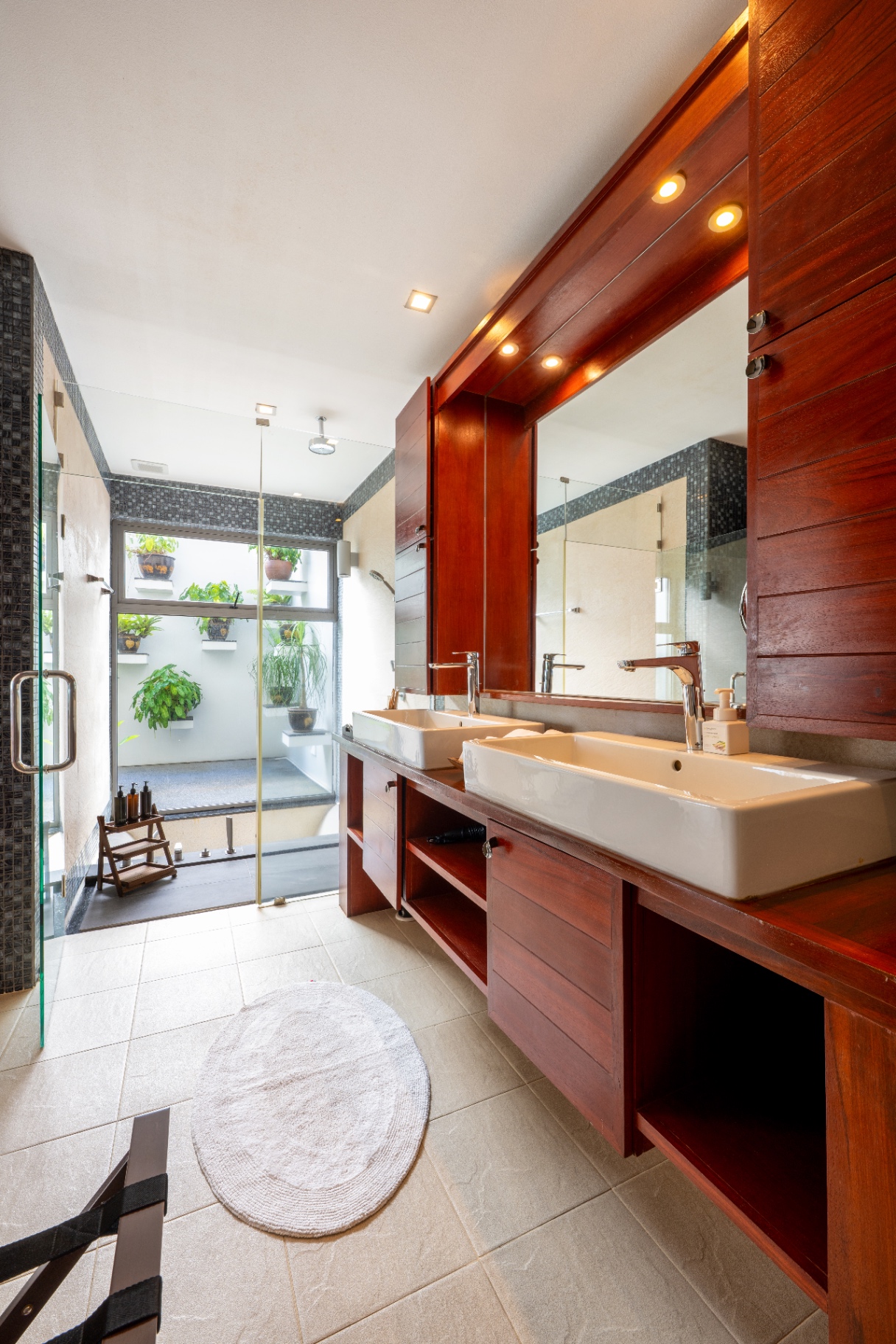 Master bathroom with double vanity and teak finishes