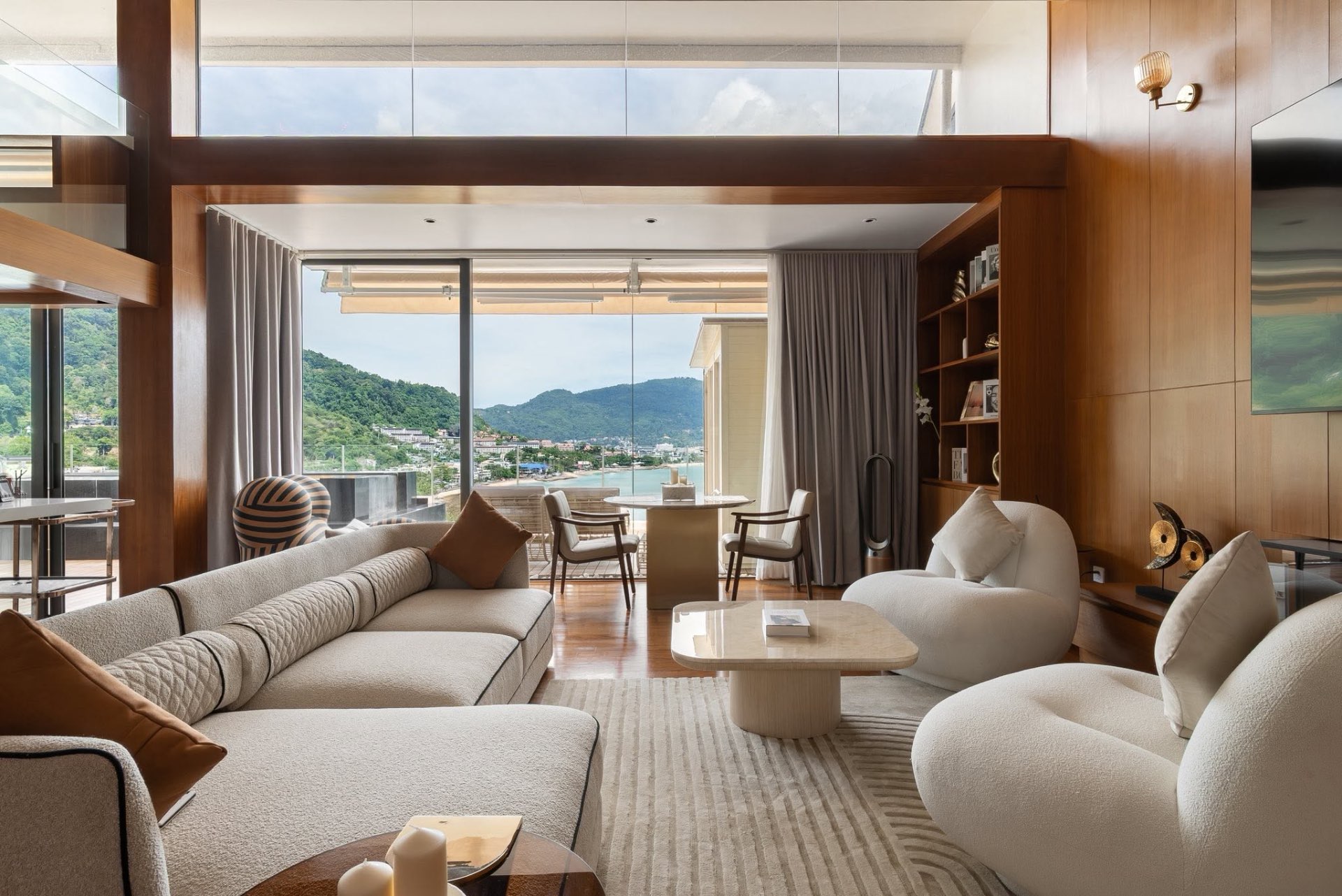 Open-plan living room with double-height windows and Andaman Sea views