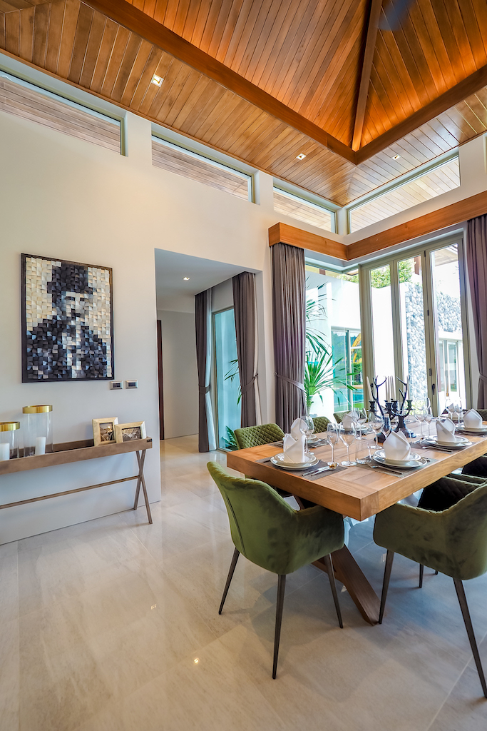 Elegant dining room with feature artwork and timber ceiling