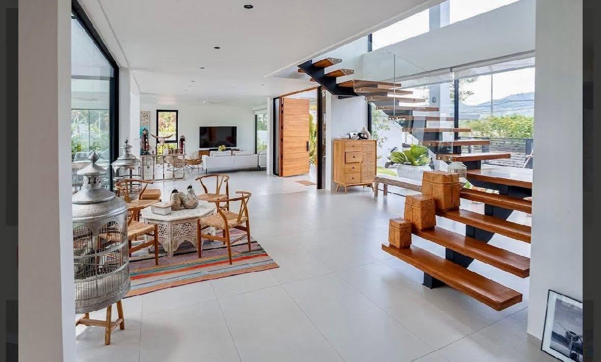 Entrance foyer with floating staircase and pivot door