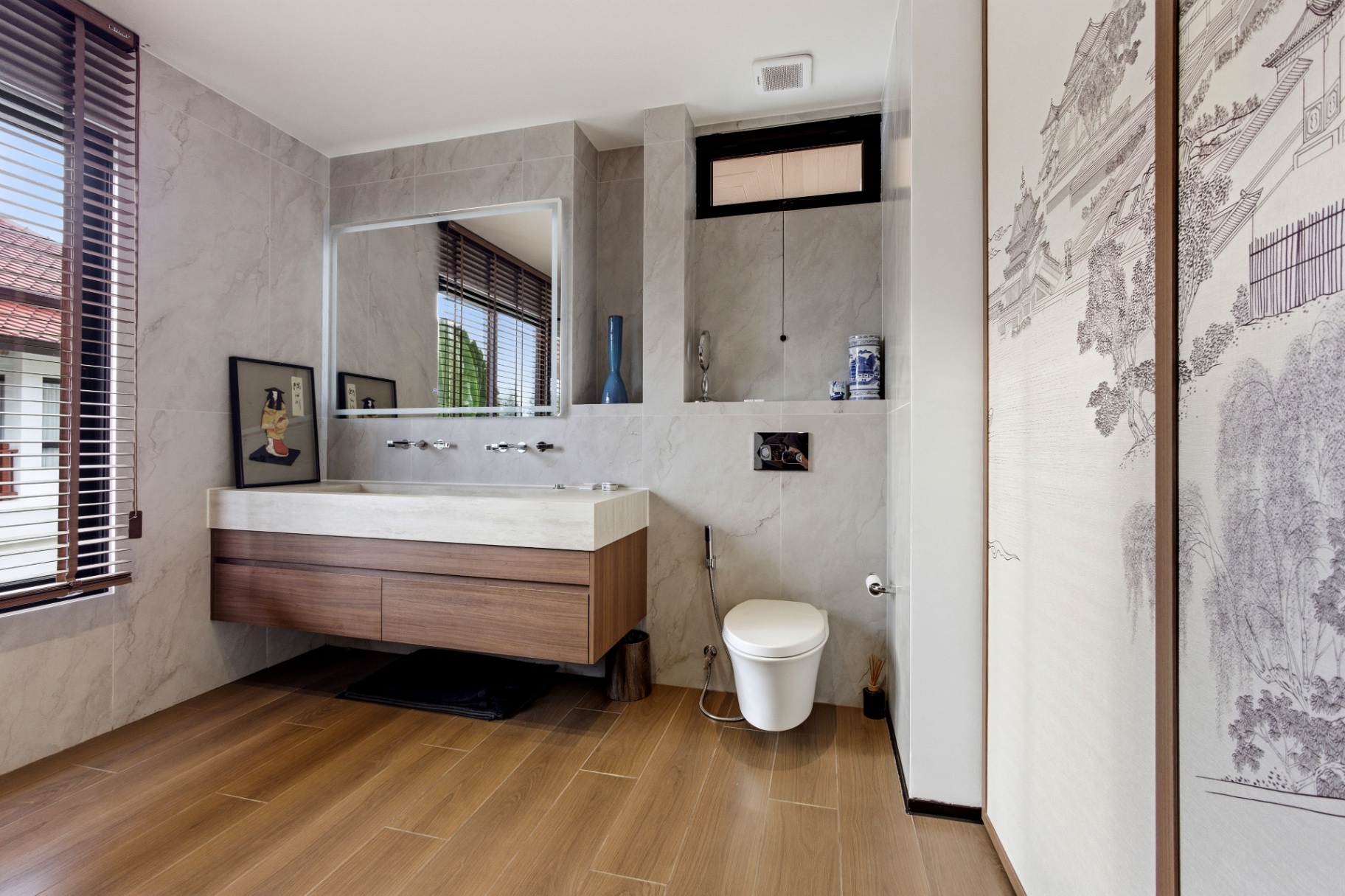 Modern bathroom with floating vanity, stone walls and wood flooring