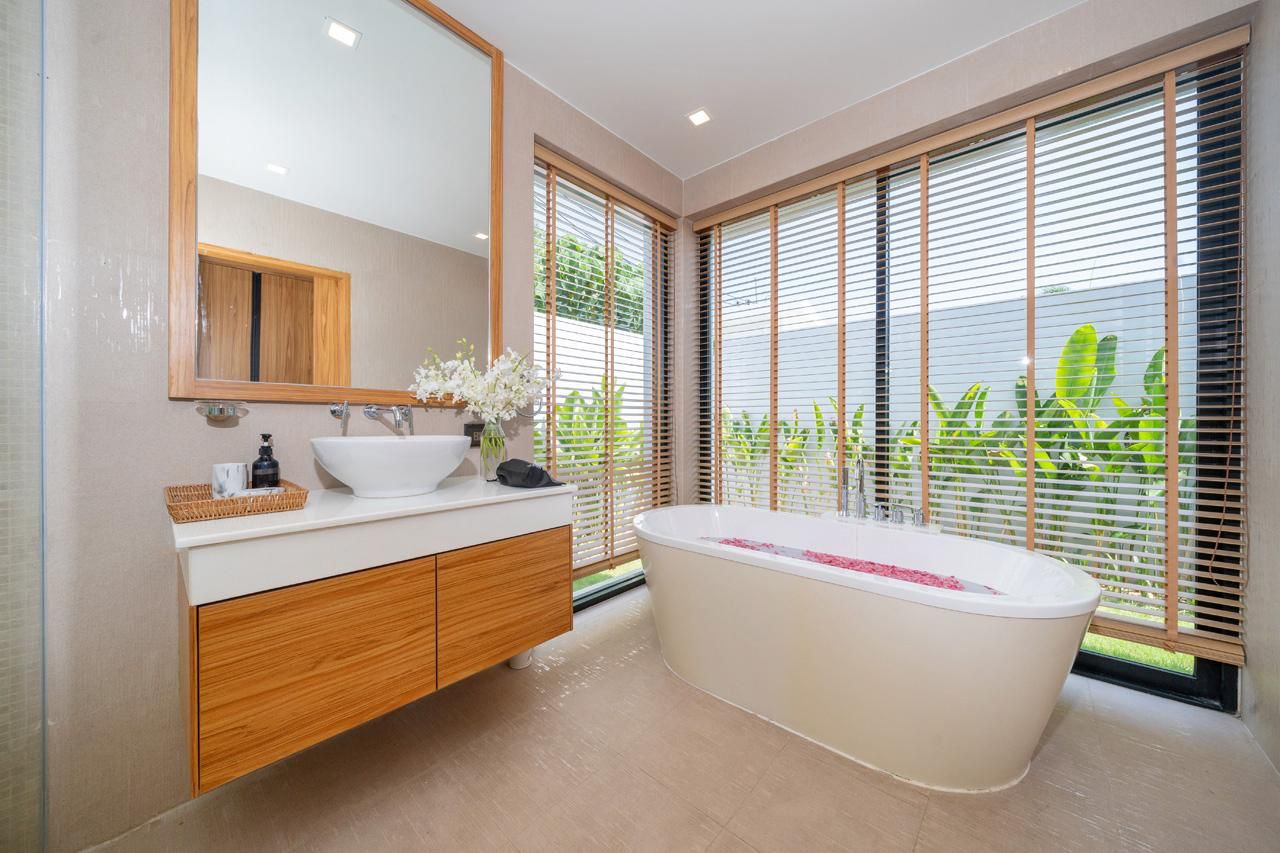 En-suite bathroom with freestanding bathtub and garden view