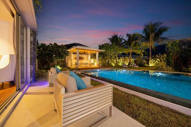 Poolside sala and lounge seating at sunset
