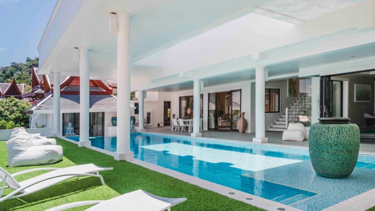 Pool deck with sun loungers, bean bags and a Thai sala pavilion