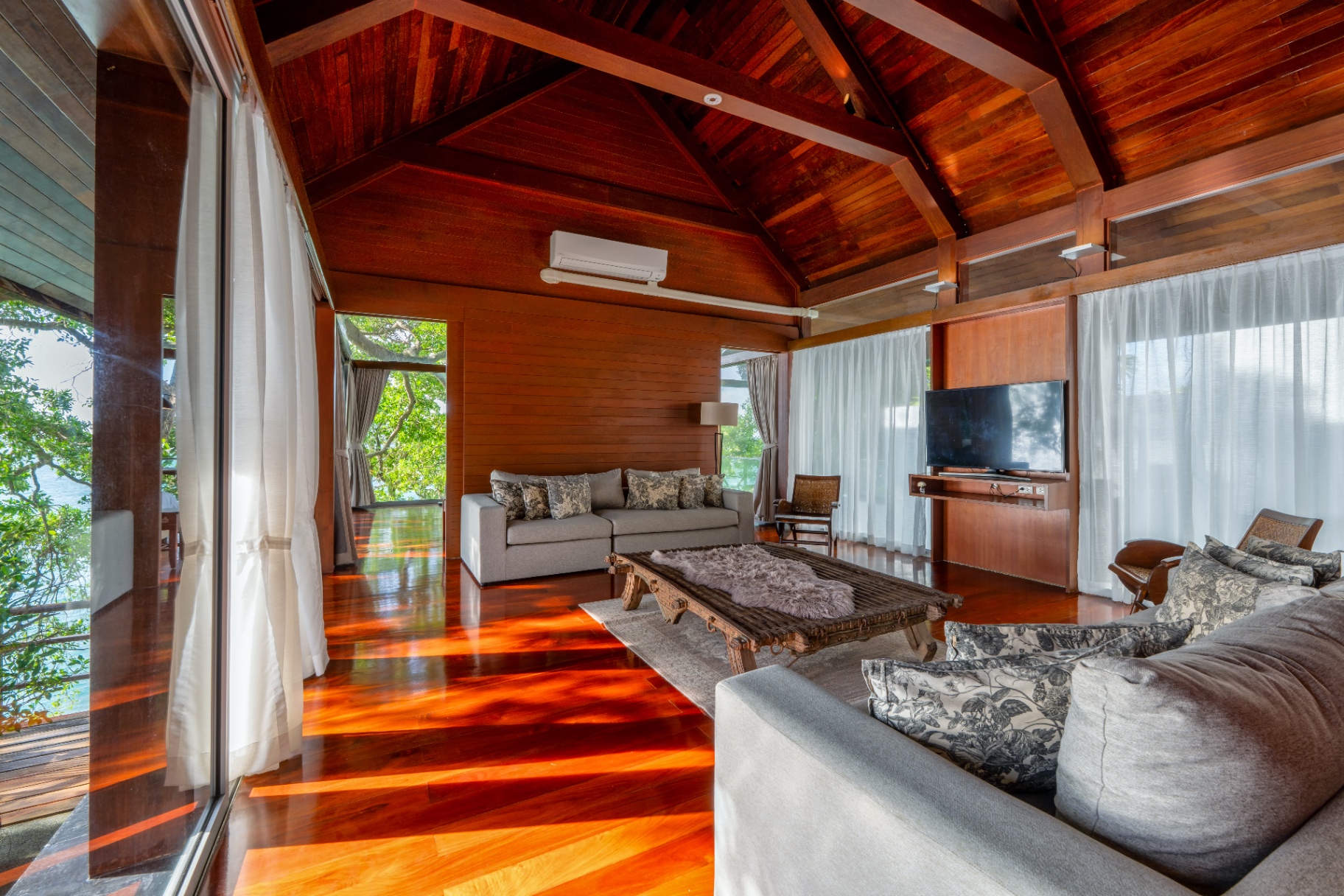 Living room with vaulted teak ceiling and ocean views