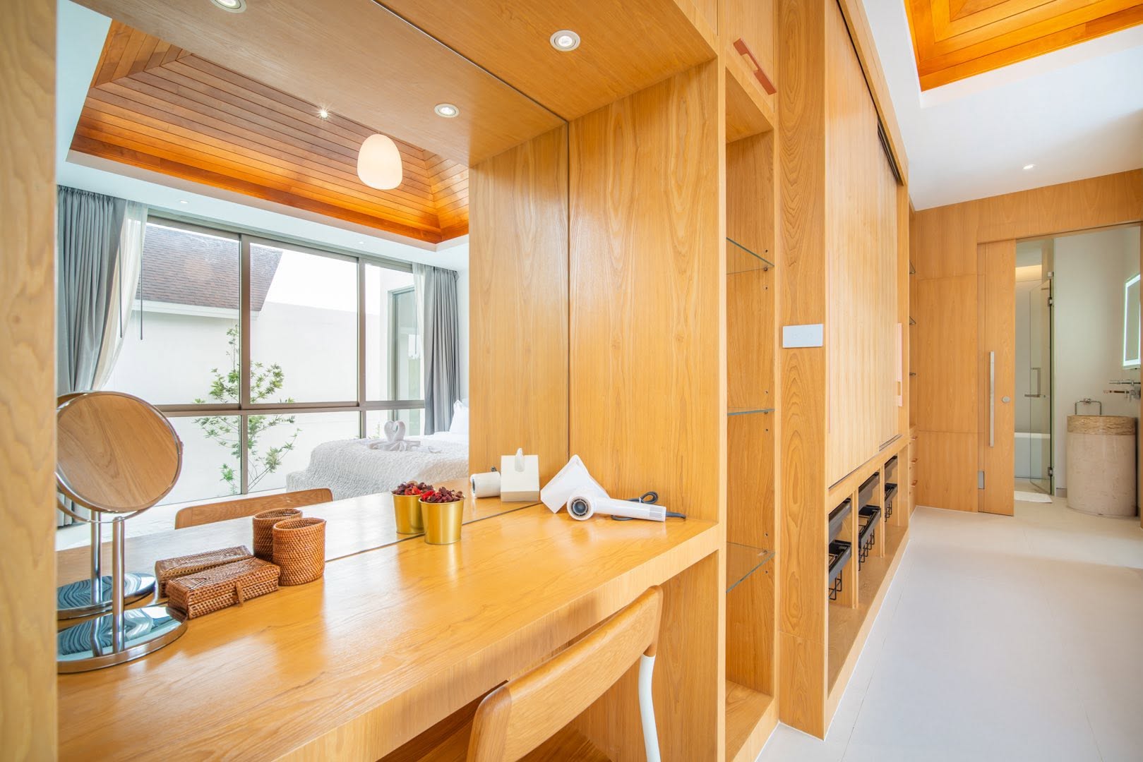 Dressing room with timber vanity and walk-in wardrobe