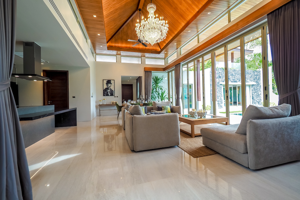 Spacious living room with marble floors and soaring timber ceiling