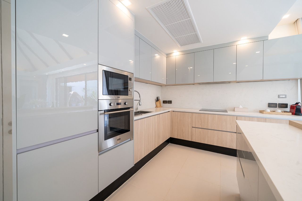 European kitchen with built-in oven and stainless appliances