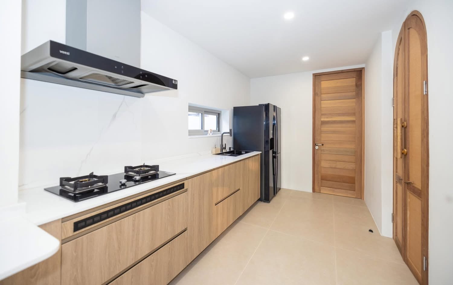 Separate Thai kitchen with gas hob and timber cabinetry