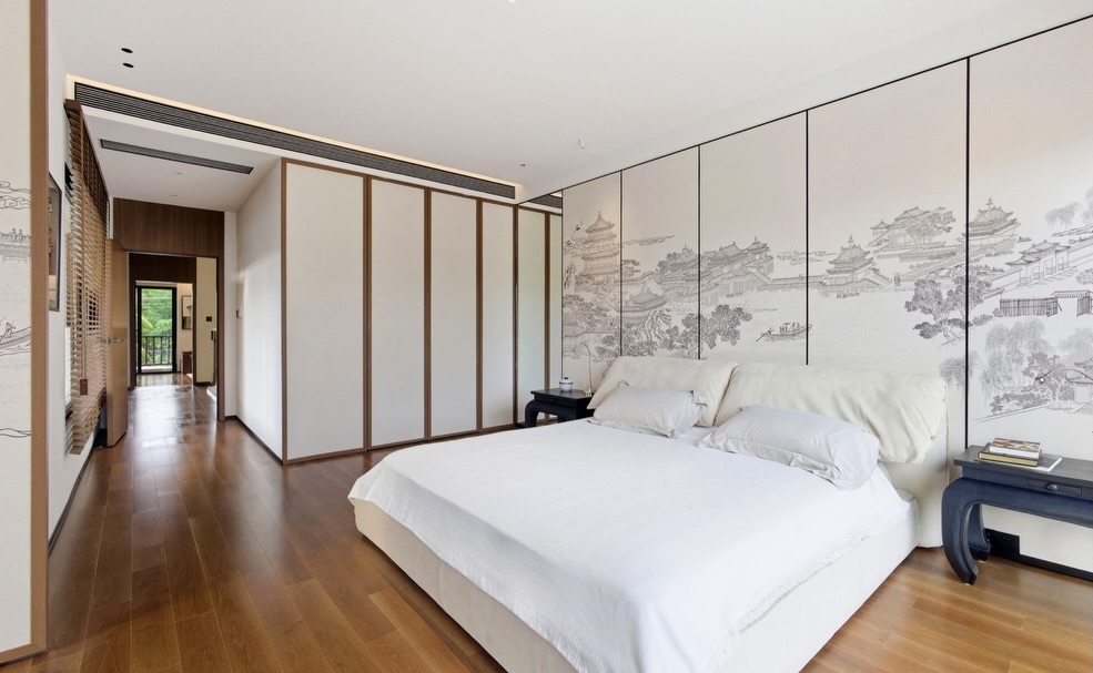 Bedroom with custom mural wall, built-in wardrobes and oak flooring