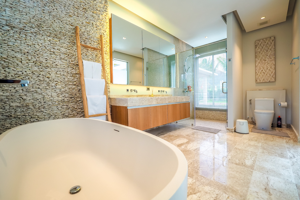 Master bathroom with freestanding tub and stone feature wall
