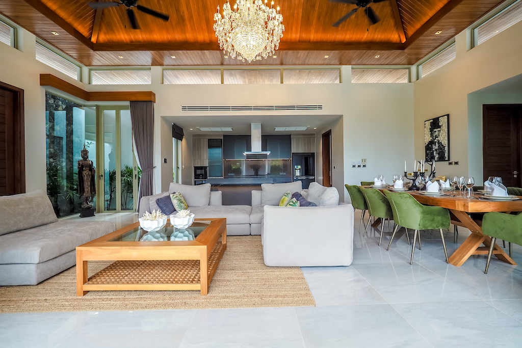 Open-plan living and dining area with crystal chandeliers