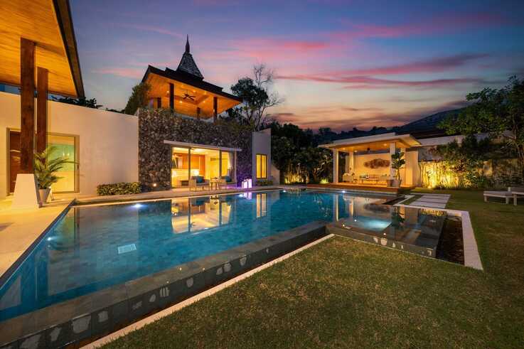 Pool and pavilions under a sunset sky