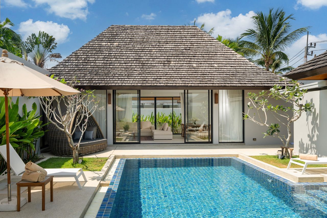 Private pool framed by traditional tropical pavilion roofs