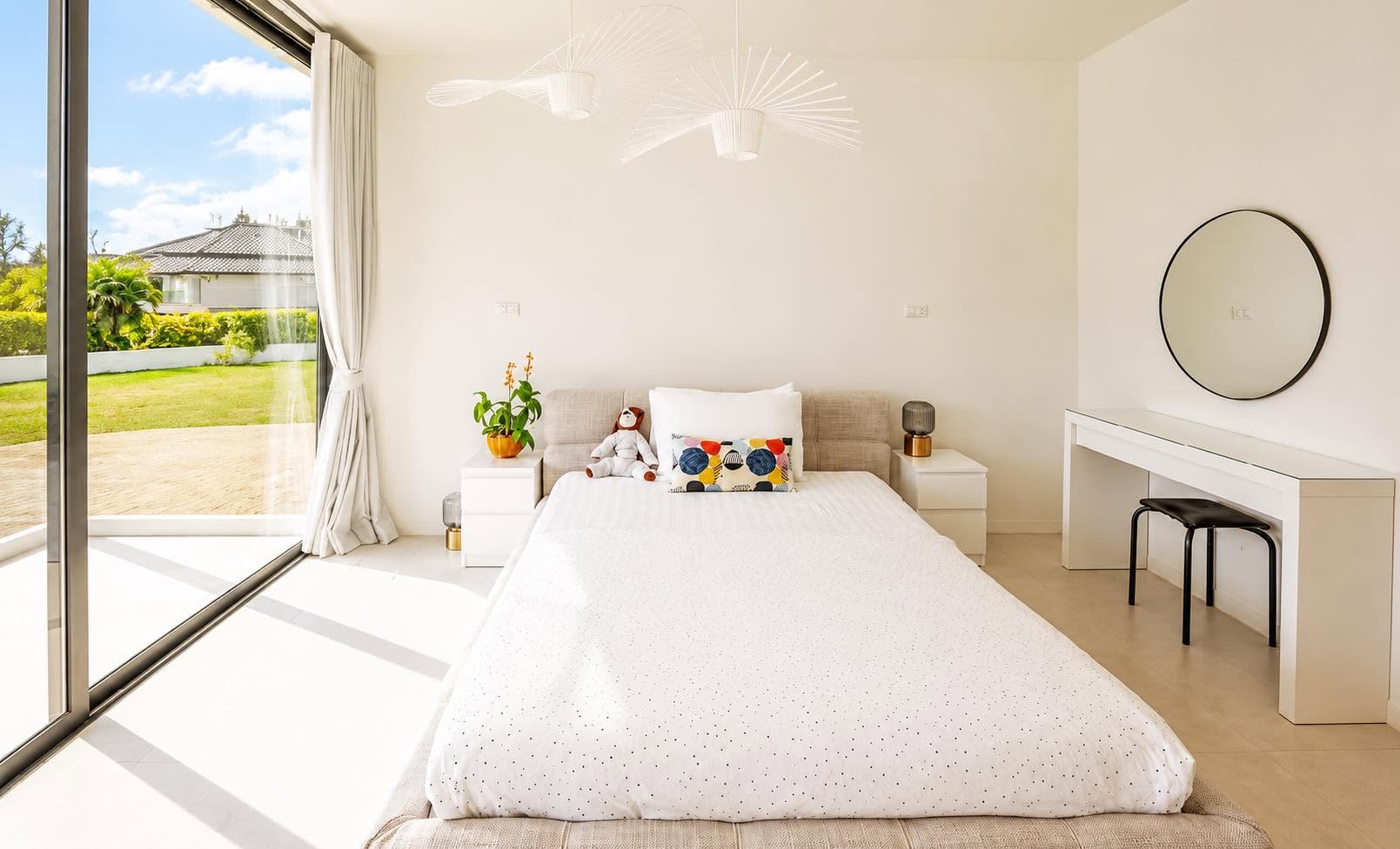 Bedroom with garden view, dressing table and round mirror