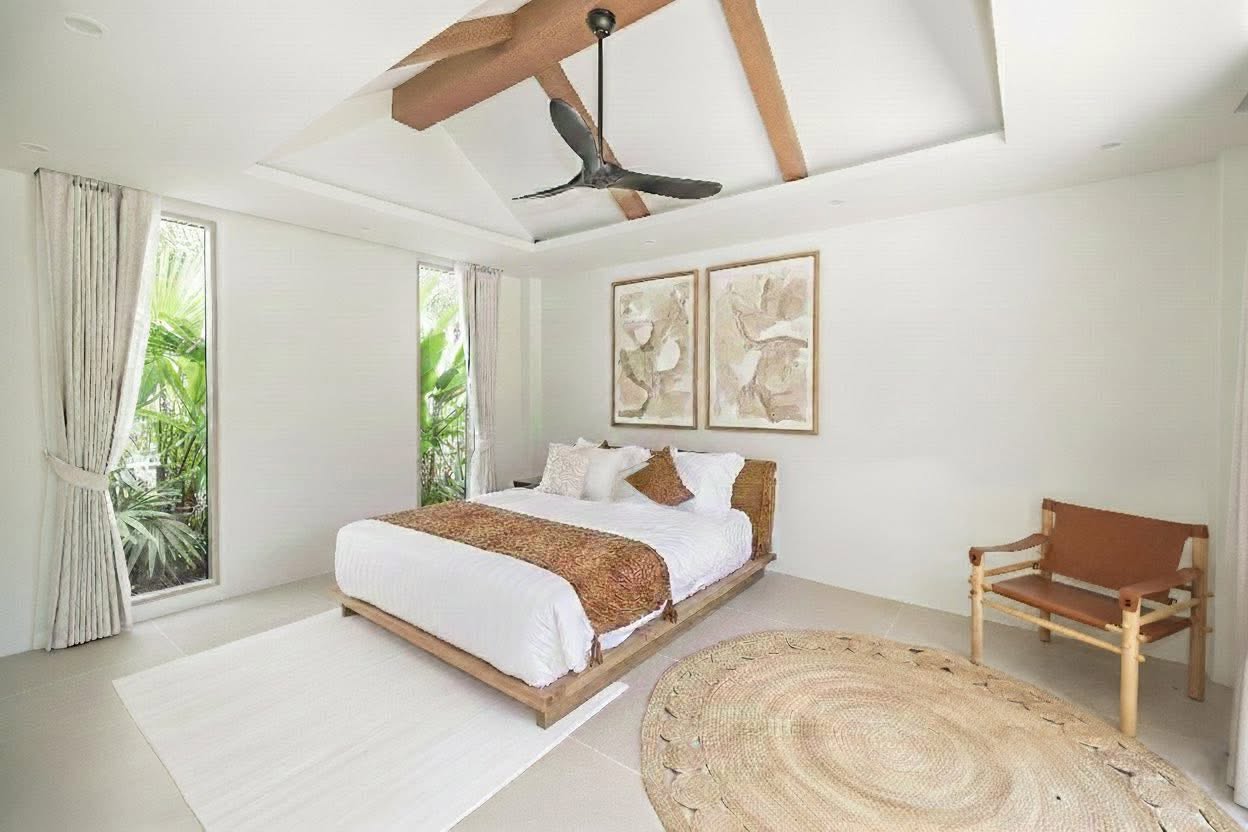 Bedroom with feature artwork and tropical garden outlook