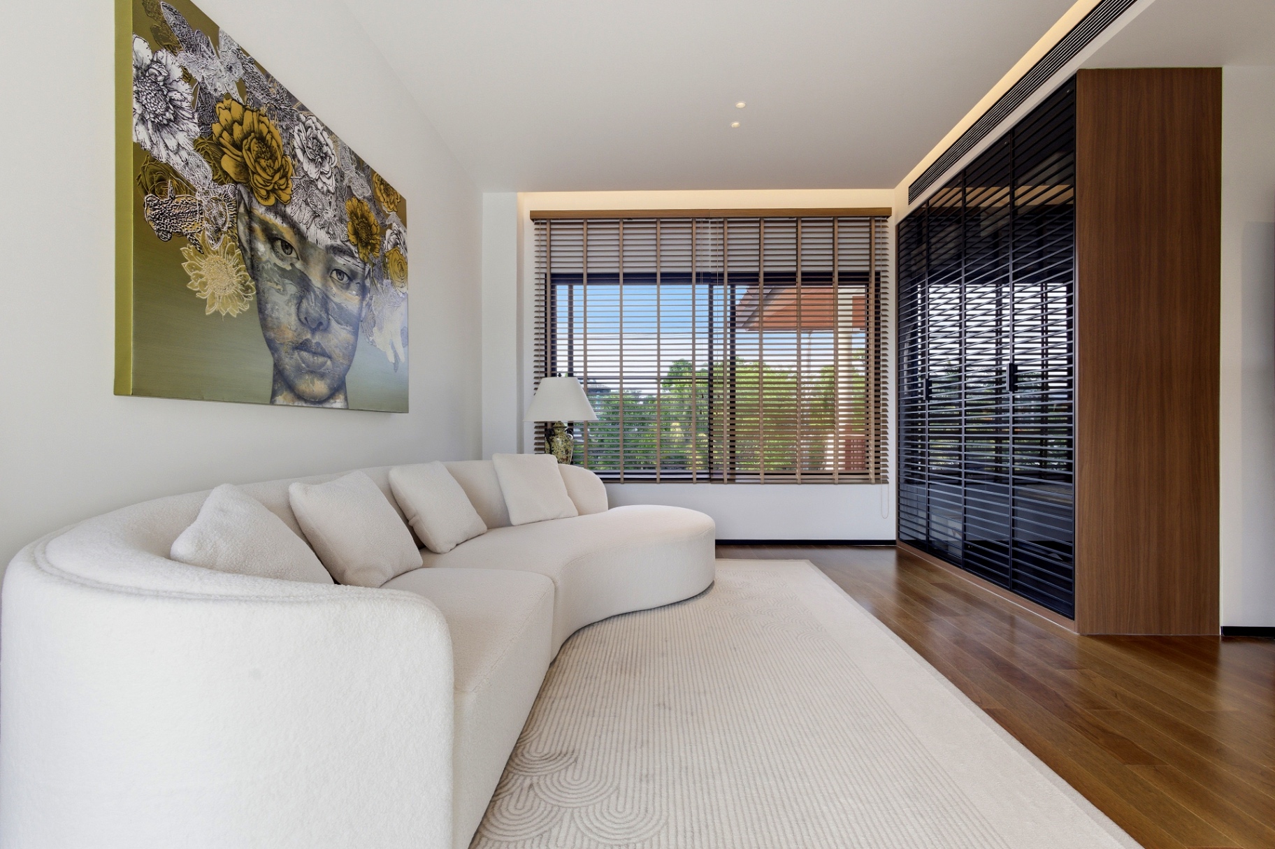 Lounge area with sculptural sofa, statement artwork and window seating