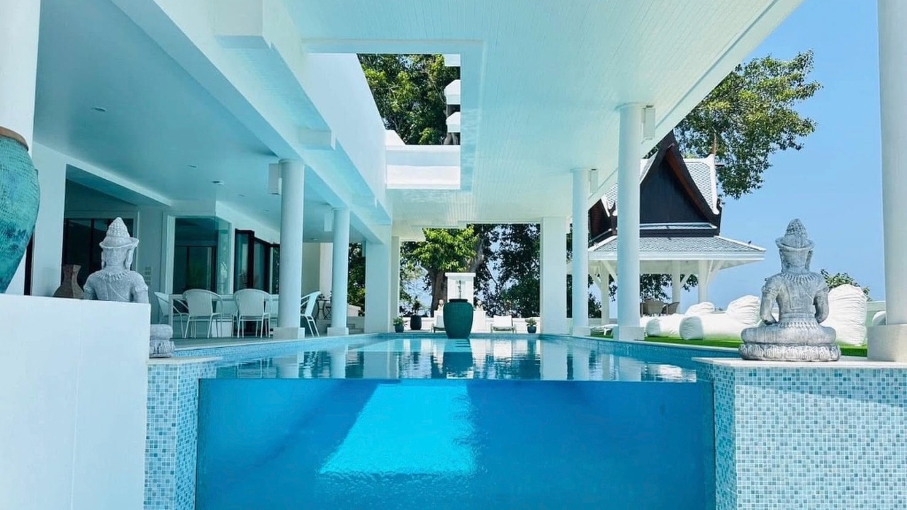 Reception pool flanked by Buddha statues and a glass viewing pavilion
