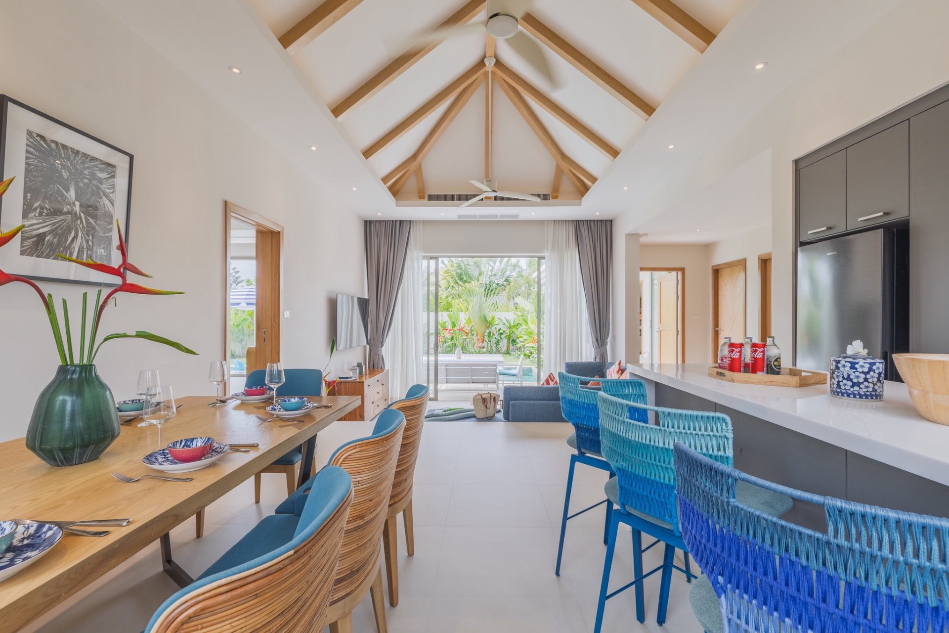 Living and dining area beneath a vaulted timber ceiling