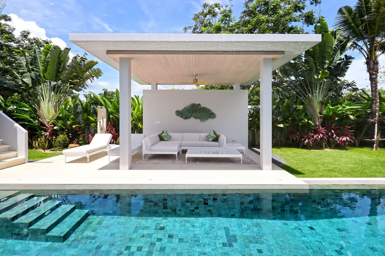 Poolside sala lounge with sun loungers and tropical garden