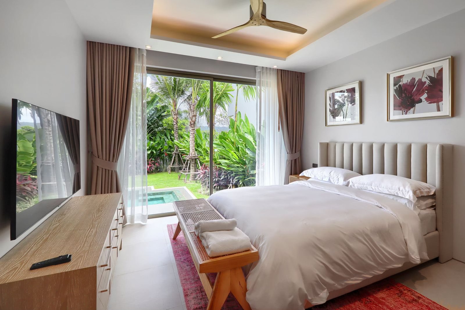 Guest bedroom with sliding doors onto the pool and garden
