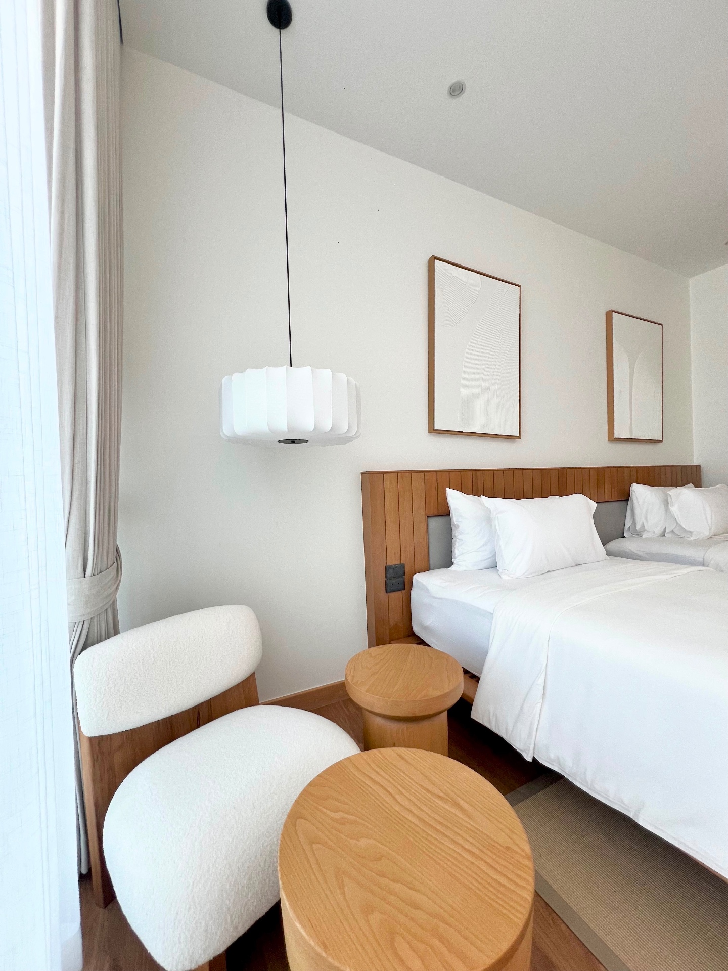 Second bedroom with cosy seating area and pendant lighting