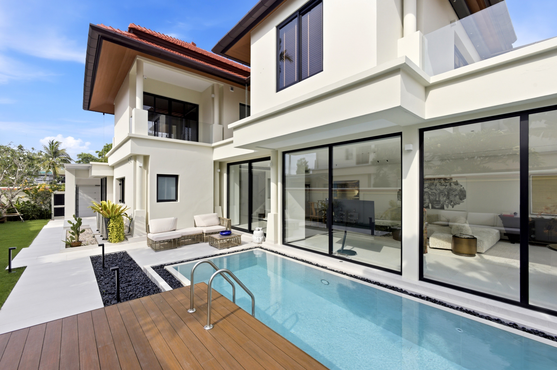 Private pool courtyard exterior with sun deck and villa facade
