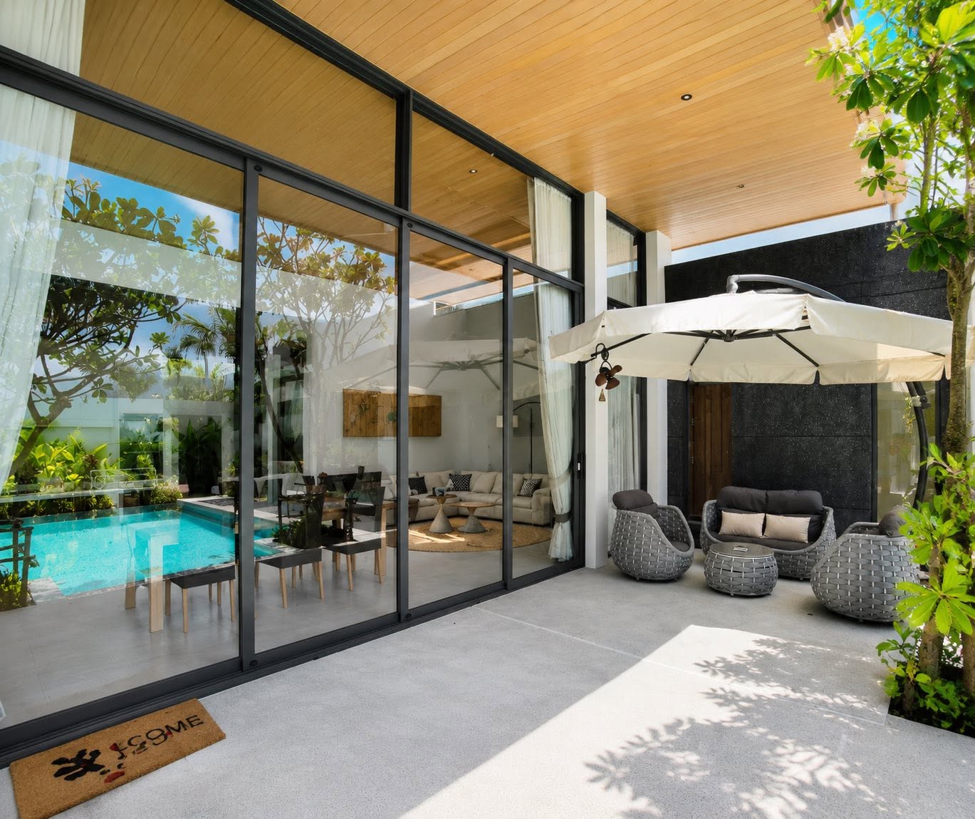 Poolside terrace with rattan lounge seating