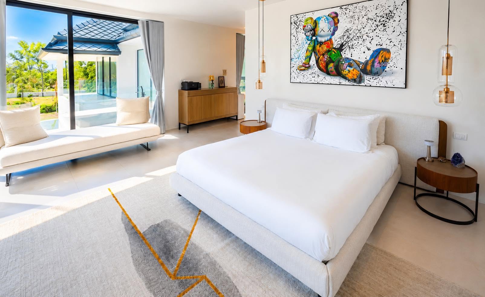 Master bedroom with statement artwork and garden access