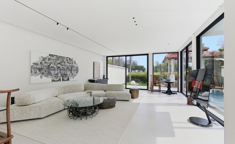 Living room with low sectional seating and golf course outlook