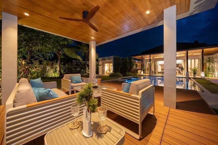 Covered terrace lounge on the timber deck at night