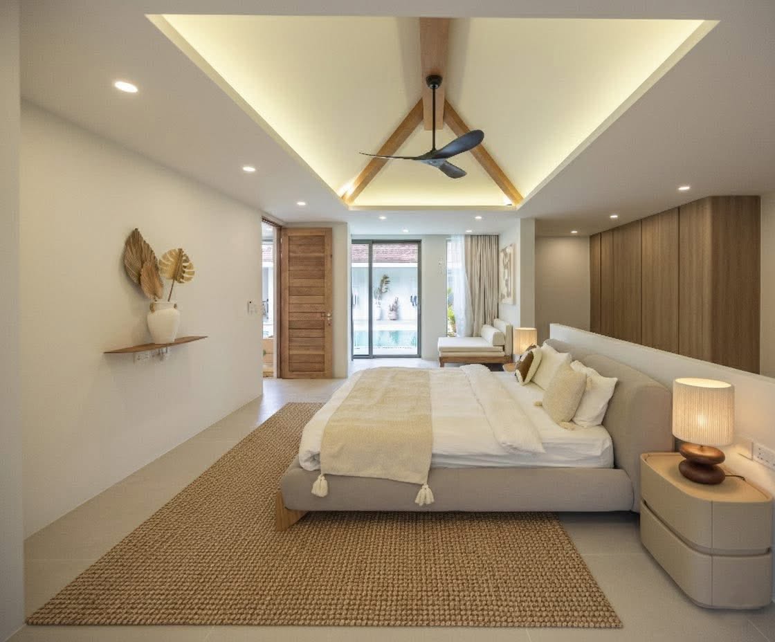 Spacious master bedroom with jute rug and tropical pool access