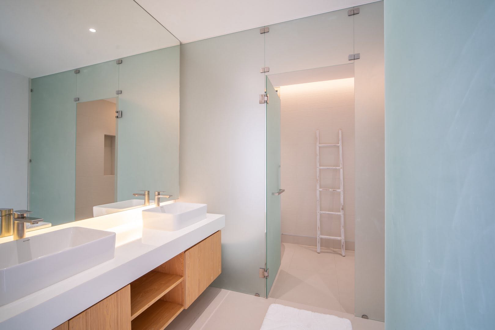 Master bathroom with double vanity and glass partition