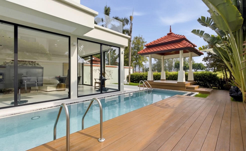 Close pool deck view toward the Thai sala and landscaped garden edge