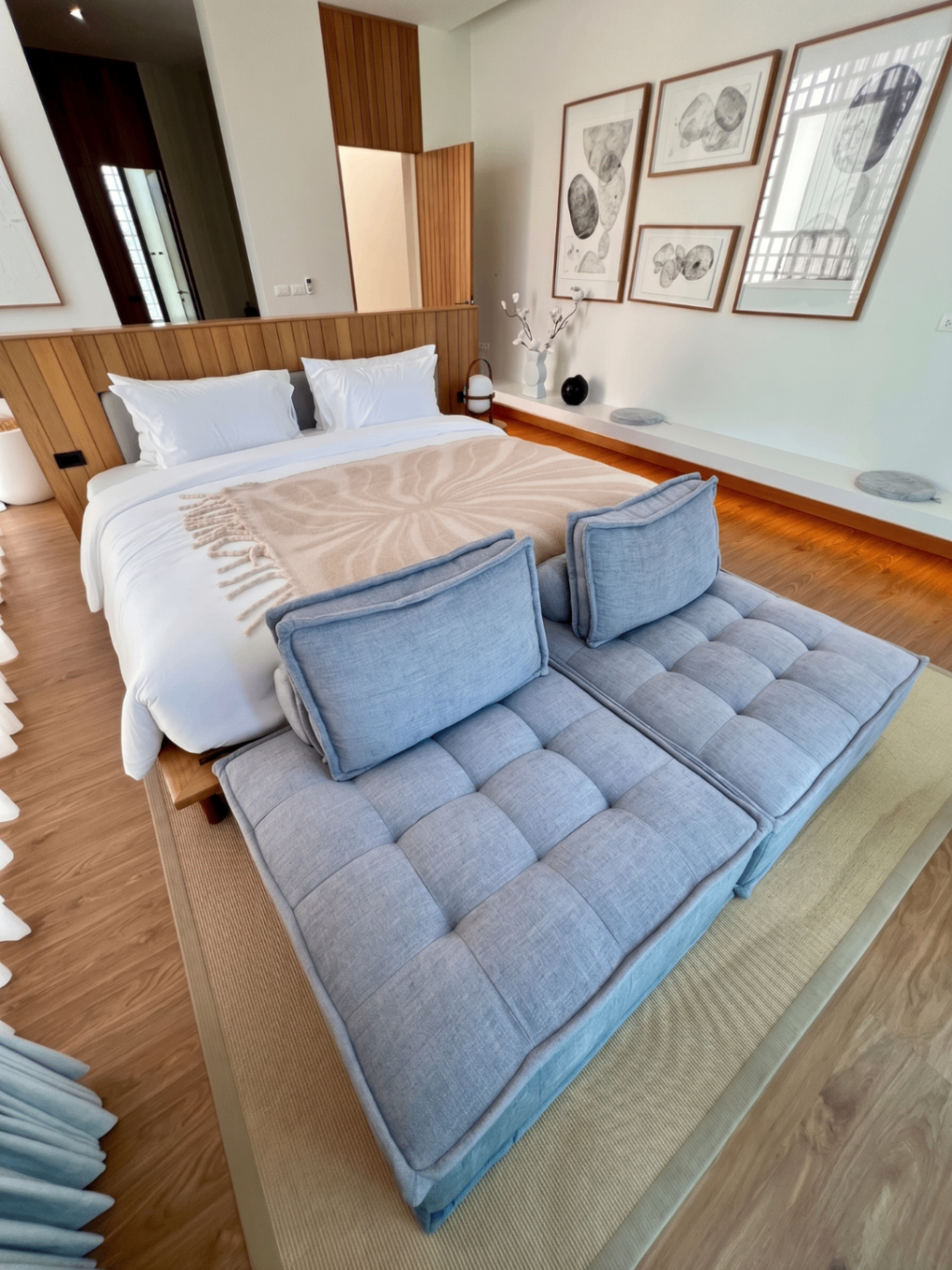 Bedroom with upholstered bench seating and framed wall art