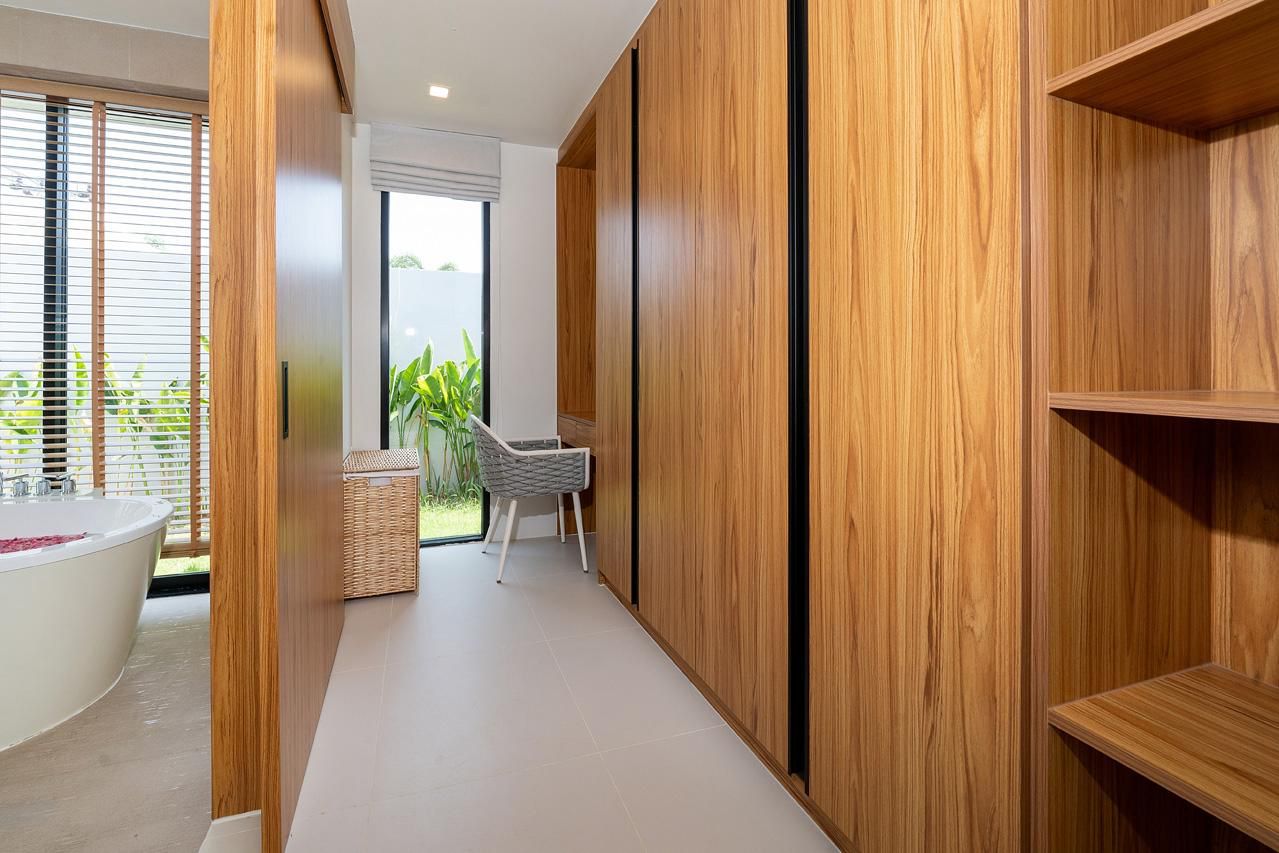 Walk-in wardrobe and dressing room with timber joinery