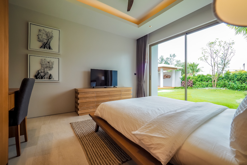 Fourth bedroom with feature artwork and garden access