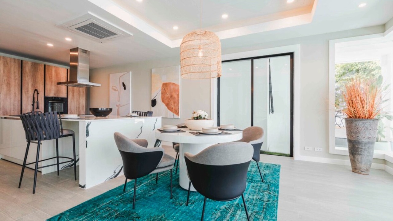 Dining area with breakfast bar, timber kitchen and teal rug